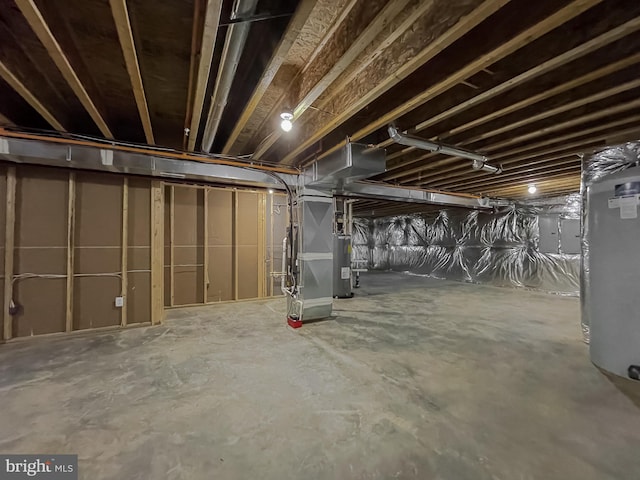 basement featuring electric panel, electric water heater, and heating unit