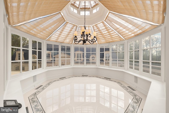 unfurnished sunroom with a skylight and a notable chandelier