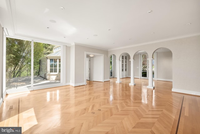 unfurnished living room featuring decorative columns, crown molding, and light parquet floors