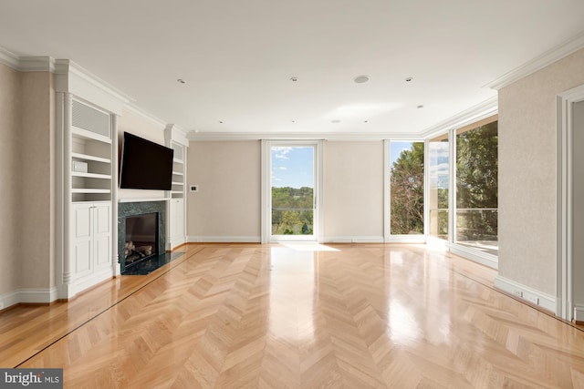 unfurnished living room featuring light parquet floors, ornamental molding, and a fireplace