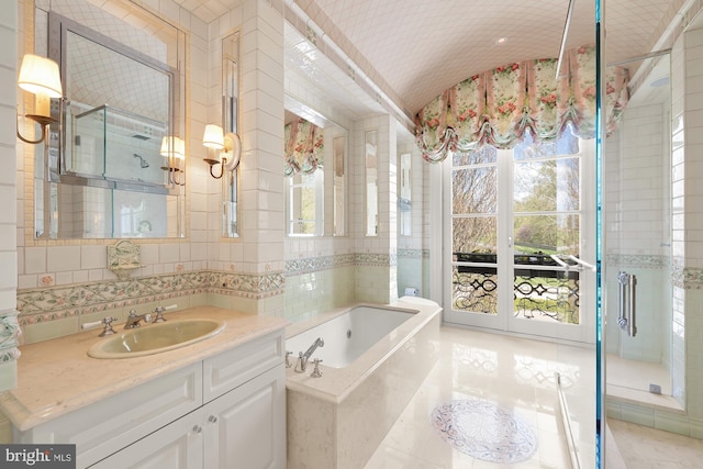 bathroom with brick ceiling, vaulted ceiling, tile walls, vanity, and plus walk in shower