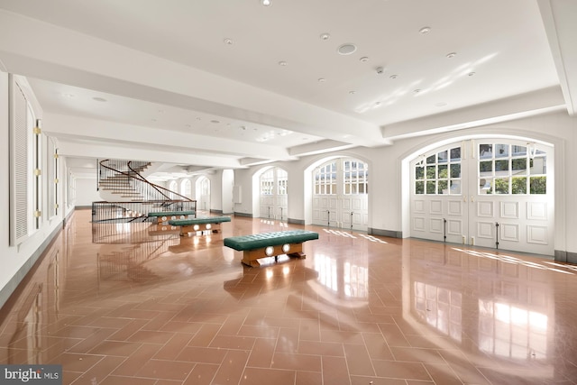 recreation room with beamed ceiling and tile patterned floors