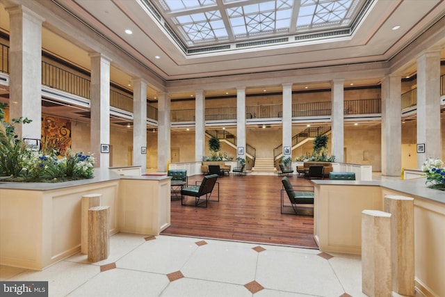 interior space featuring a skylight and ornate columns