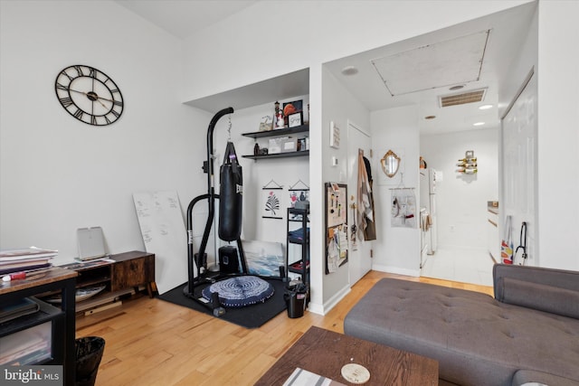 exercise area featuring light hardwood / wood-style flooring