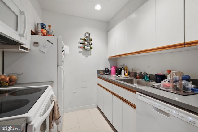 kitchen featuring white cabinets, white appliances, sink, and light tile flooring