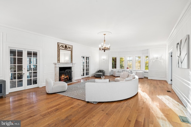 living room featuring ornamental molding, french doors, and hardwood / wood-style floors