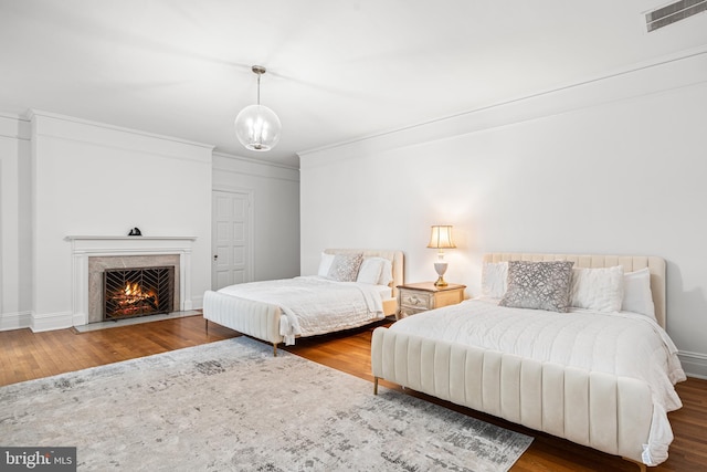 bedroom featuring hardwood / wood-style flooring and ornamental molding