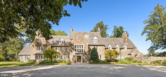 english style home featuring a playground