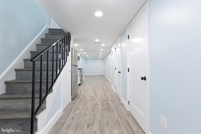 stairway with light wood-type flooring