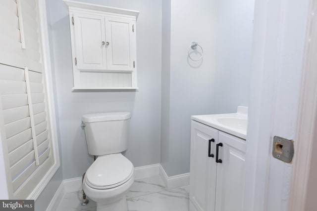 bathroom featuring toilet, tile floors, and vanity