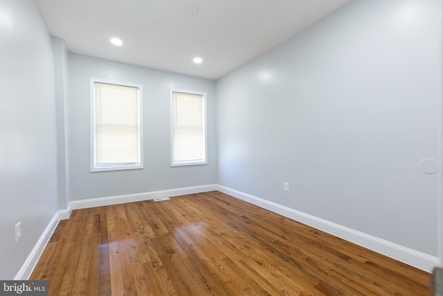 spare room with dark wood-type flooring