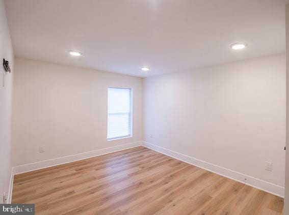 unfurnished room with light hardwood / wood-style floors