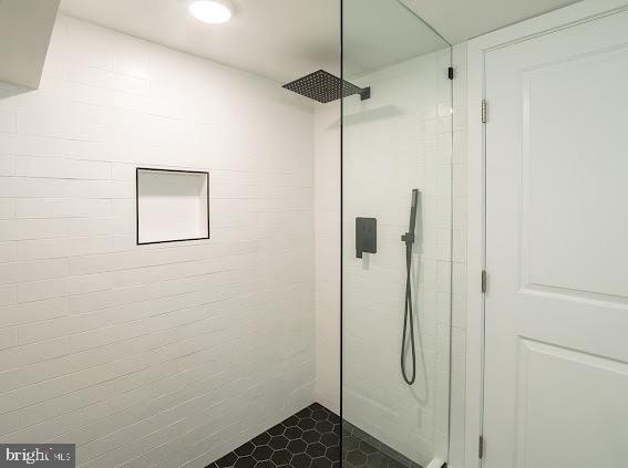 bathroom with a tile shower