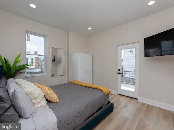 bedroom with light hardwood / wood-style flooring and access to outside