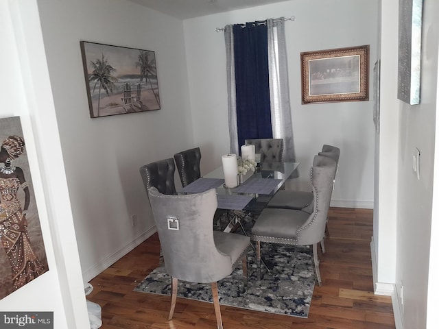 dining space with dark hardwood / wood-style floors