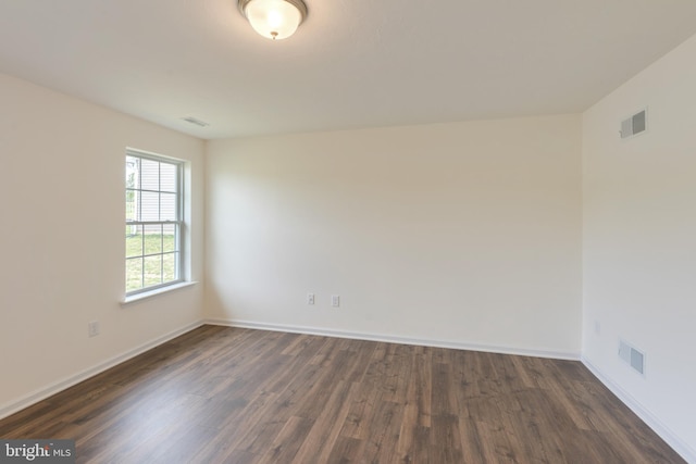 spare room featuring dark hardwood / wood-style floors