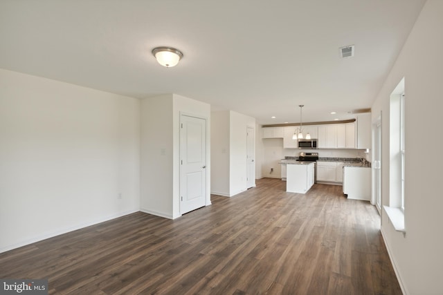 unfurnished living room with dark hardwood / wood-style flooring