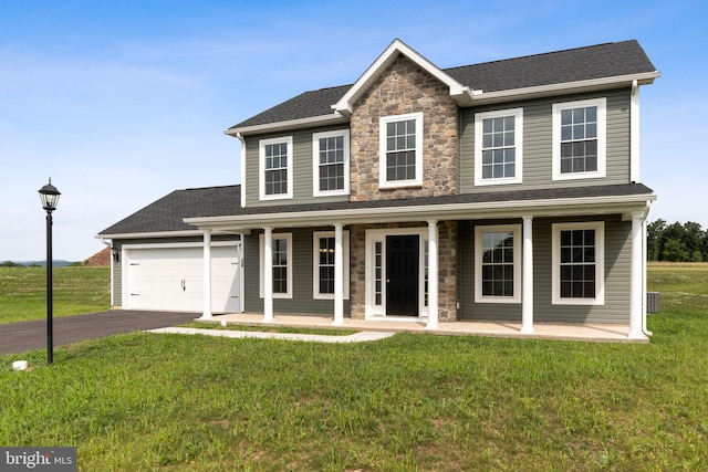 view of front of house featuring a garage, a porch, and a front lawn