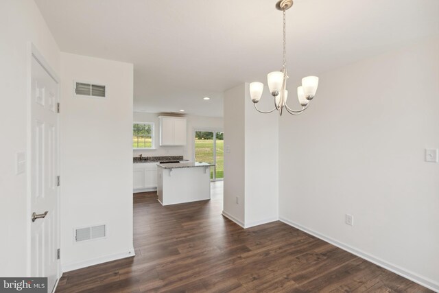 interior space with dark hardwood / wood-style floors, sink, and an inviting chandelier