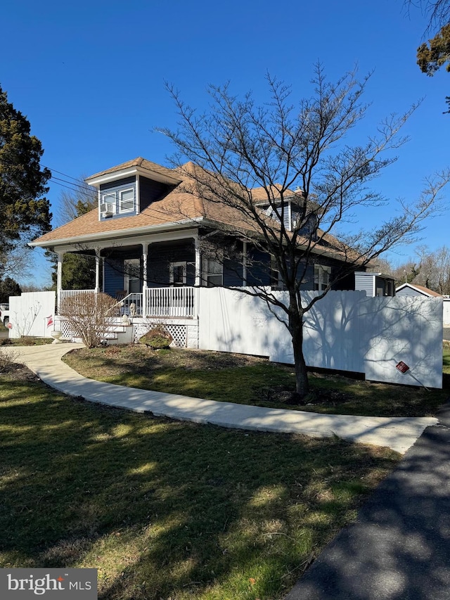 view of property exterior with a yard and a porch