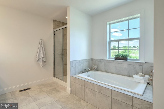 bathroom with a wealth of natural light, tile floors, and independent shower and bath