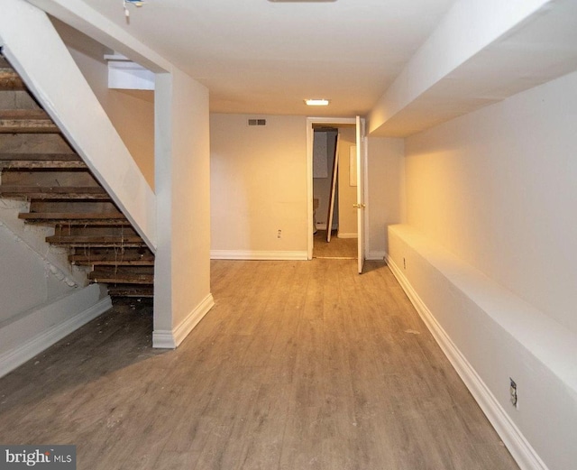 basement with light hardwood / wood-style flooring