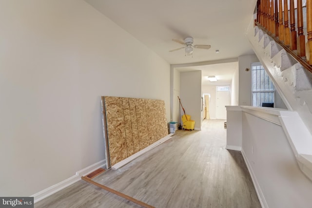 additional living space with ceiling fan and light wood-type flooring