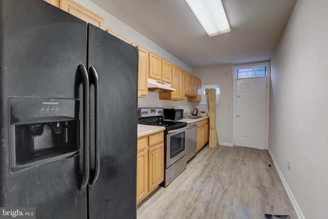 kitchen with light brown cabinetry, light wood-type flooring, black appliances, and sink