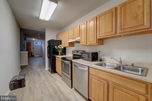 kitchen featuring black appliances, ceiling fan, sink, light wood-type flooring, and light brown cabinetry