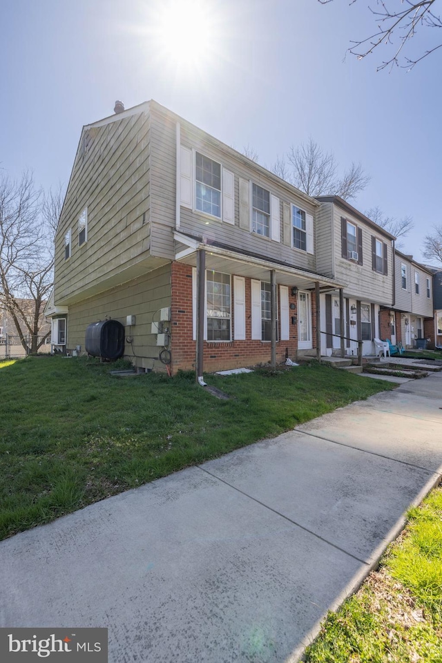 view of property featuring a front lawn