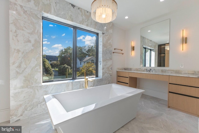 bathroom with vanity and a bath