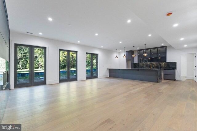 staircase featuring wood-type flooring and an inviting chandelier