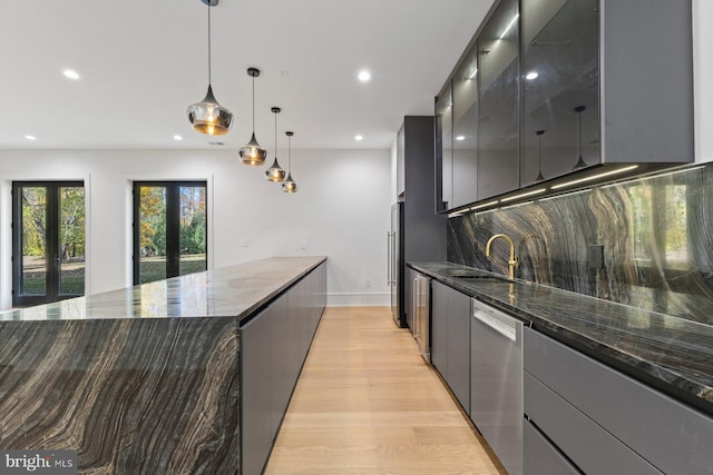 kitchen with dark stone counters, french doors, hanging light fixtures, and stainless steel dishwasher