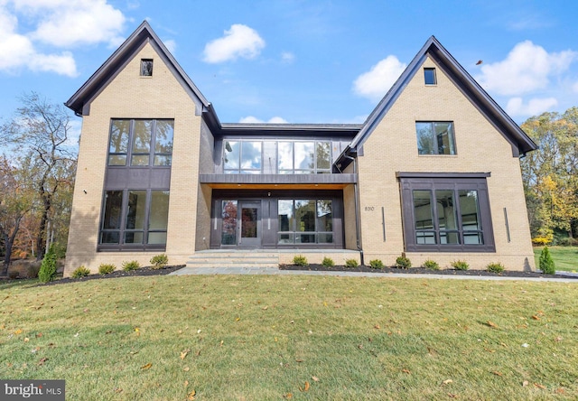 rear view of house featuring a lawn