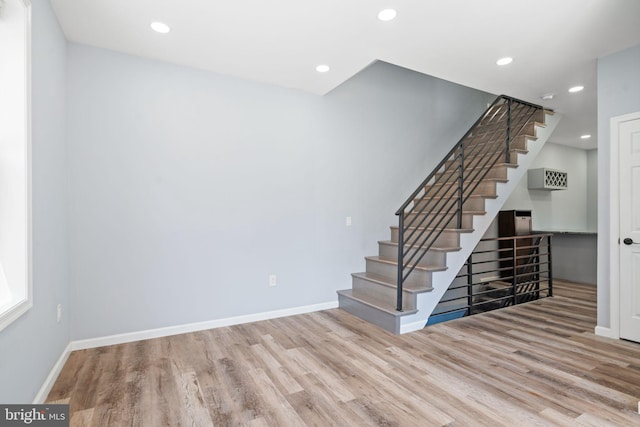 stairs with hardwood / wood-style floors