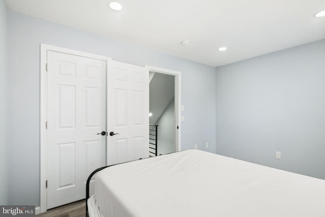 bedroom featuring hardwood / wood-style floors and a closet