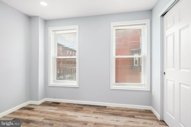 unfurnished room with light hardwood / wood-style flooring