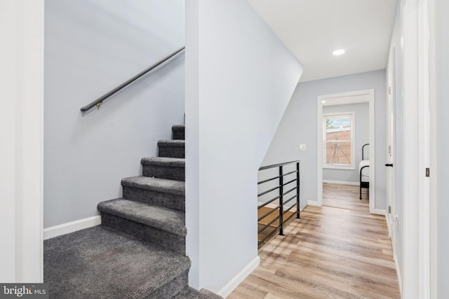 stairs with hardwood / wood-style flooring