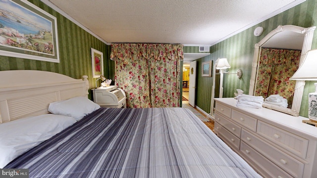 bedroom with a textured ceiling and ornamental molding