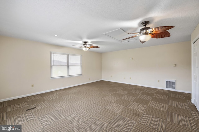 empty room featuring a textured ceiling and ceiling fan