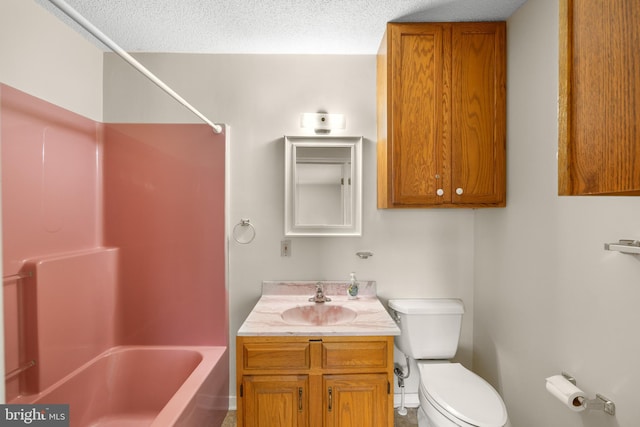 full bathroom featuring a textured ceiling, large vanity, shower / bathing tub combination, and toilet