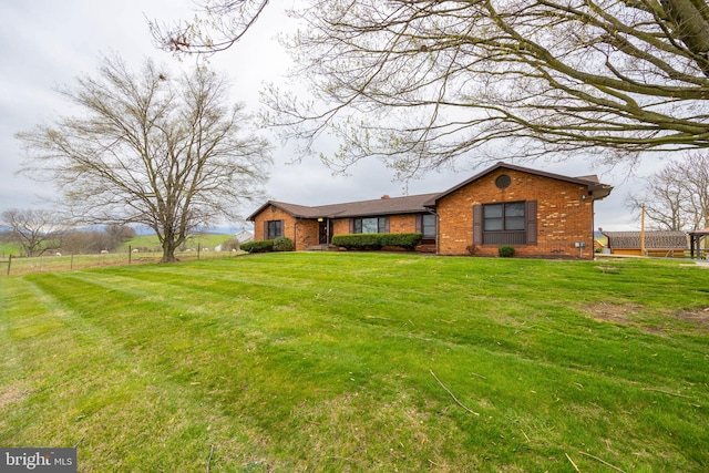 ranch-style home with a front lawn