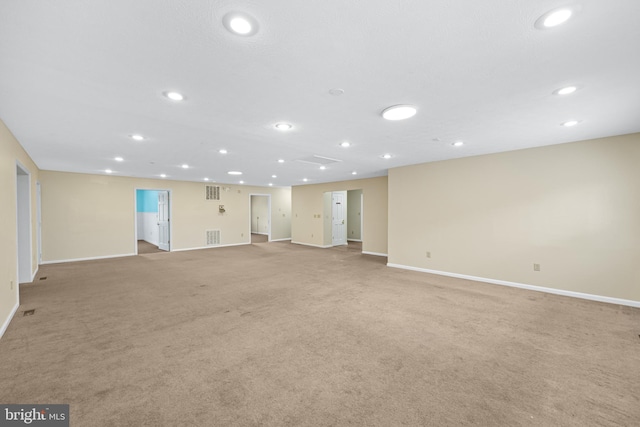 unfurnished living room featuring light colored carpet