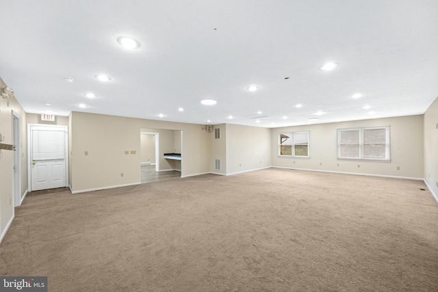 basement featuring light colored carpet