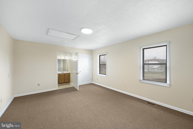 carpeted spare room featuring a healthy amount of sunlight