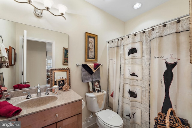 bathroom featuring toilet and vanity with extensive cabinet space