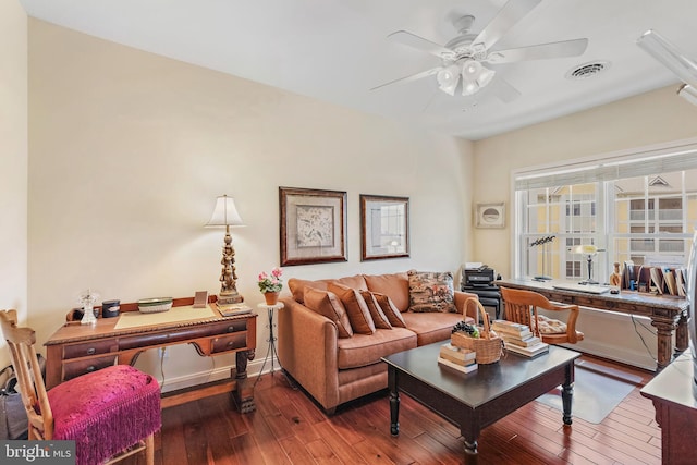 living room with dark hardwood / wood-style flooring and ceiling fan