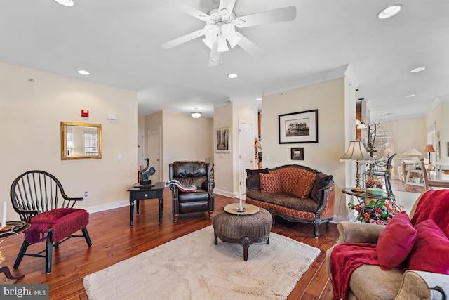 living room with ceiling fan, crown molding, and dark wood-type flooring