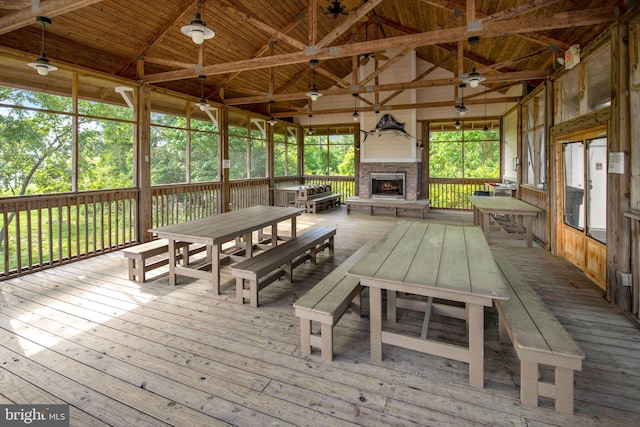 unfurnished sunroom featuring a fireplace, lofted ceiling with beams, and wood ceiling