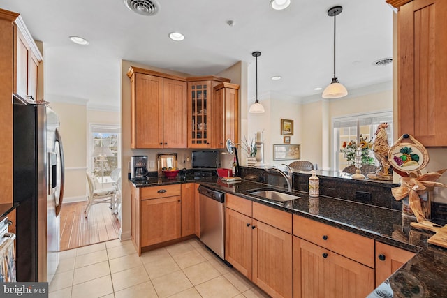 kitchen featuring pendant lighting, stainless steel appliances, light tile flooring, and sink